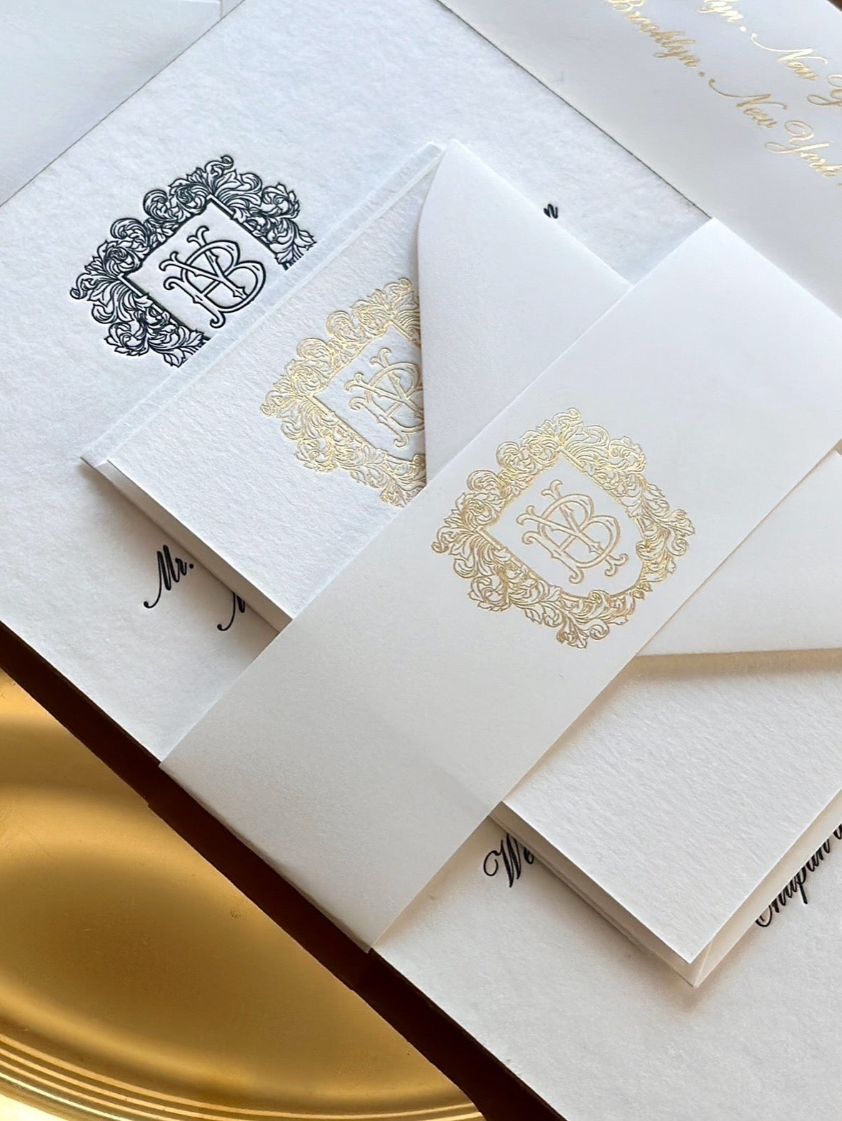 A modern take on regal elegance. All black letterpress ink invite card with gold foil stamp  accents.